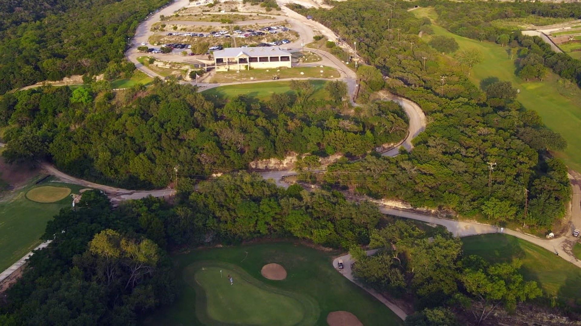 Aerial view of Cedar Creek Golf Course fairways and clubhouse in San Antonio.