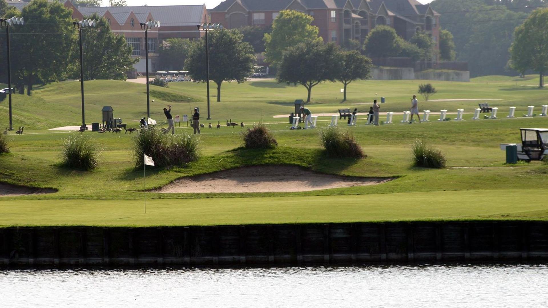 Practice facilities beside a pond at The Courses at Watters Creek in Plano.