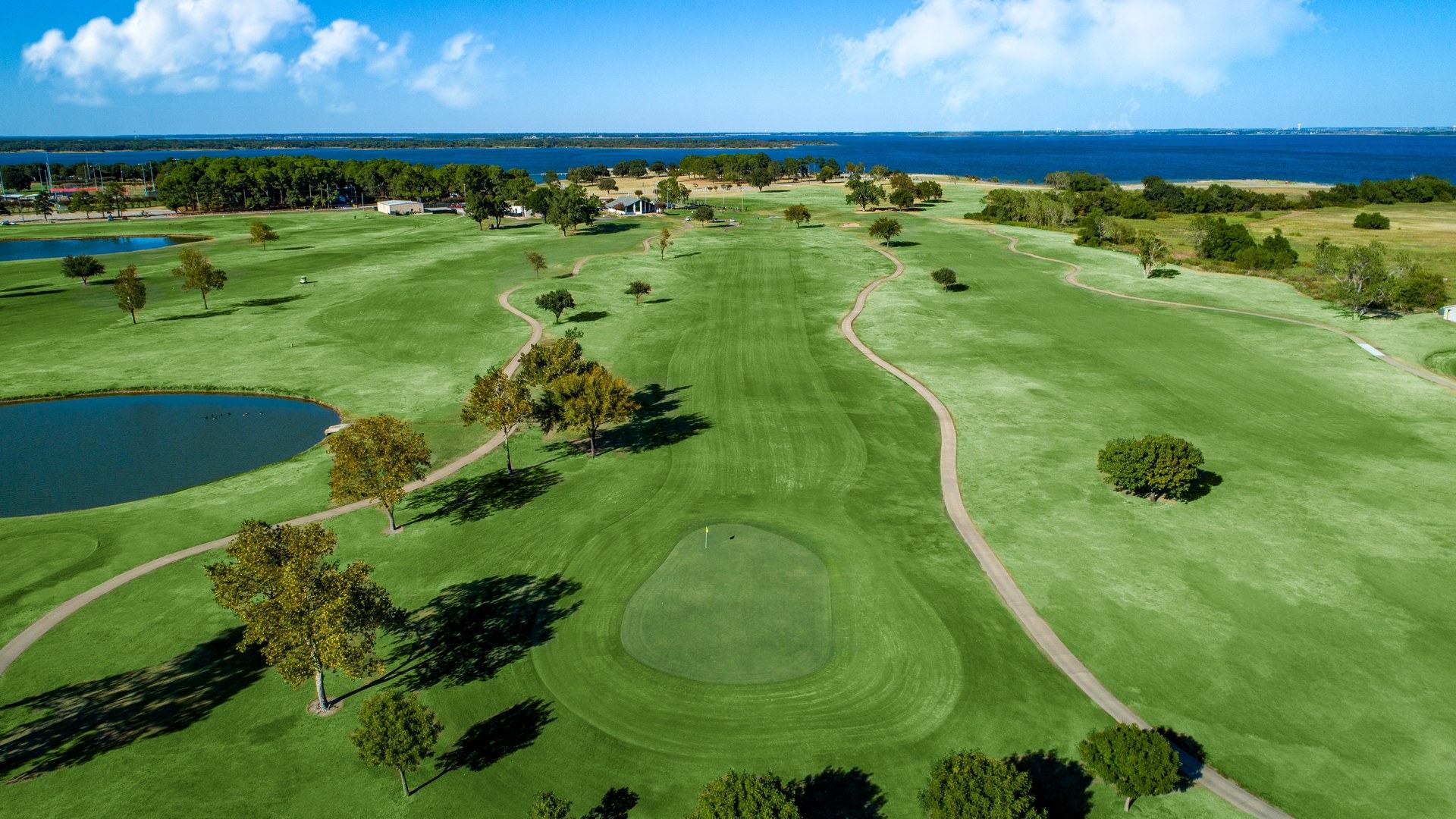 Aerial view of Lake Park Championship Course with fairways and Lewisville Lake in the distance.