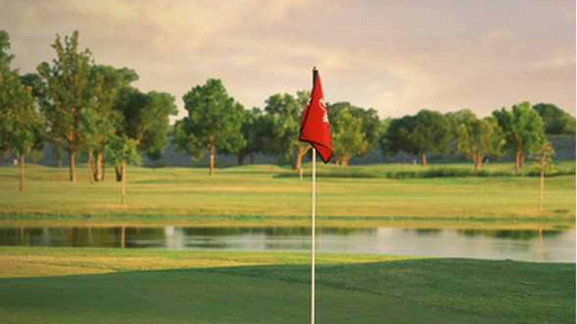 Red flag on a green beside water at Lake Park Executive Golf Course in Lewisville.