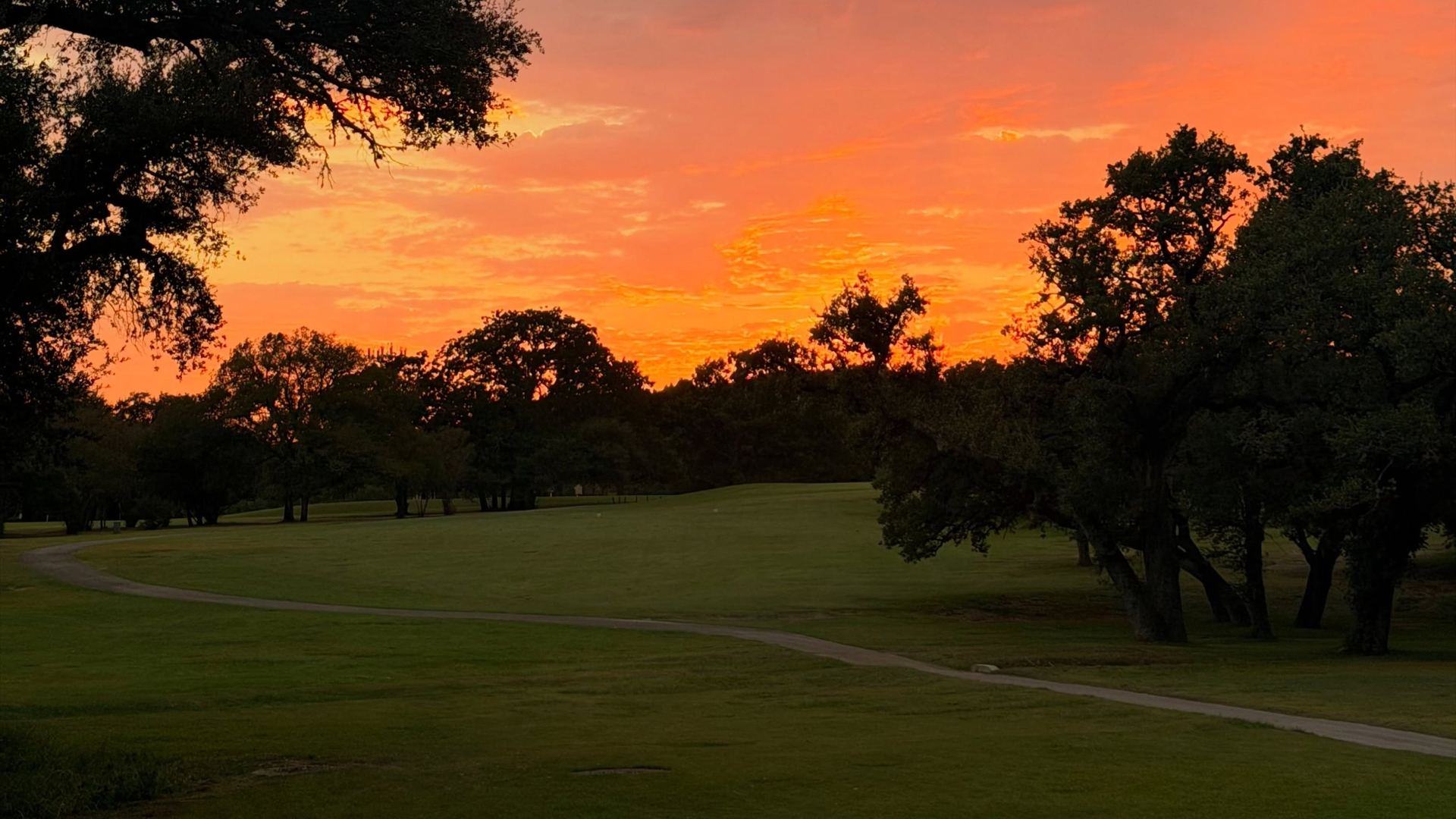 Sunset above the tree-lined fairway at Lions Municipal Golf Course in Austin.