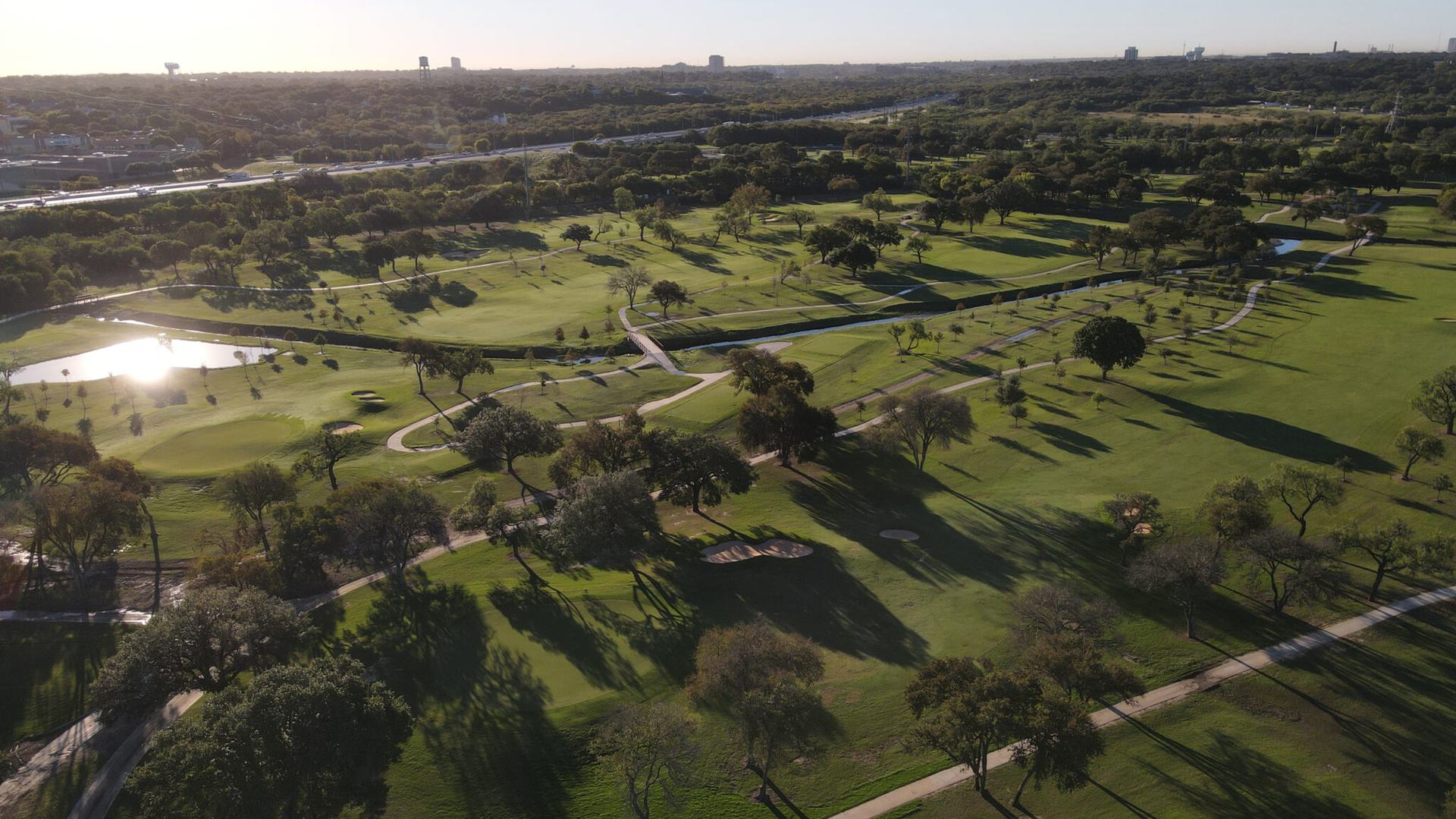 Aerial view of tree-lined fairways at Olmos Basin Golf Course in San Antonio.