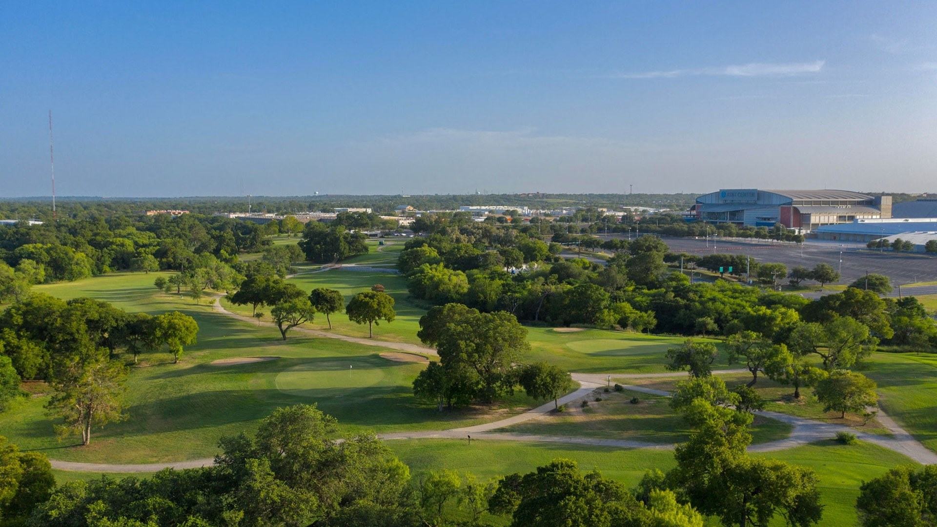Aerial view of Willow Springs Golf Course with the Alamodome in the San Antonio skyline.