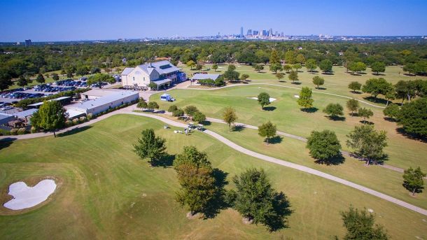 Aerial view of Cedar Crest Golf Course, its clubhouse, and the Dallas skyline.