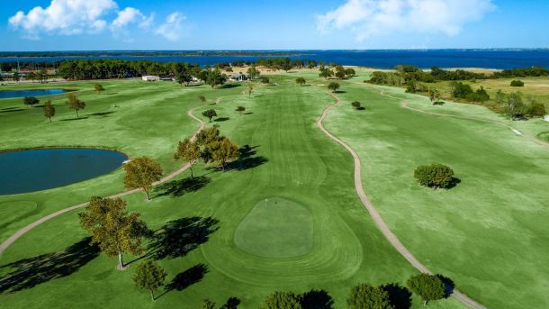 Aerial view of Lake Park Championship Course with fairways and Lewisville Lake in the distance.