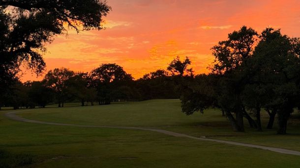 Sunset above the tree-lined fairway at Lions Municipal Golf Course in Austin.